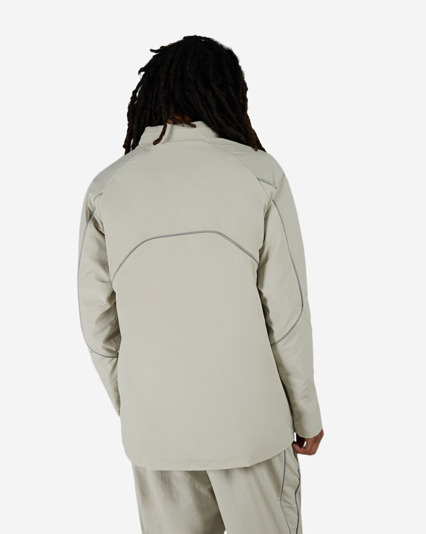 Shop New Balance Reflective Woven Jacket MJ61E2BY-SHY beige