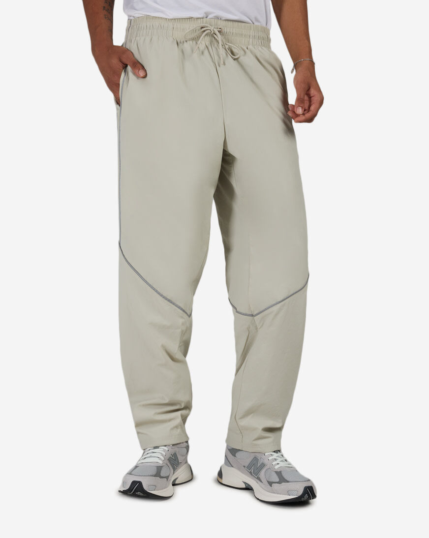 Shop New Balance Reflective Woven Pants MB61Q27Z-SHY beige